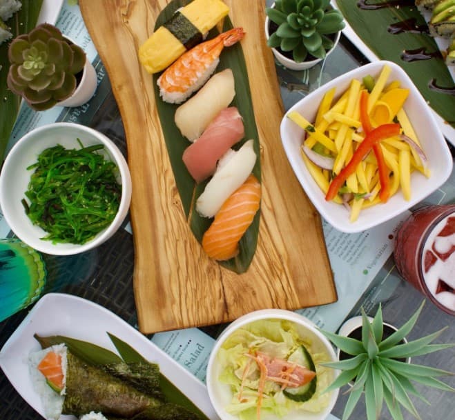 All you can eat sushi dinner spread with nigiri, sides, and Japanese dishes at Sparkly