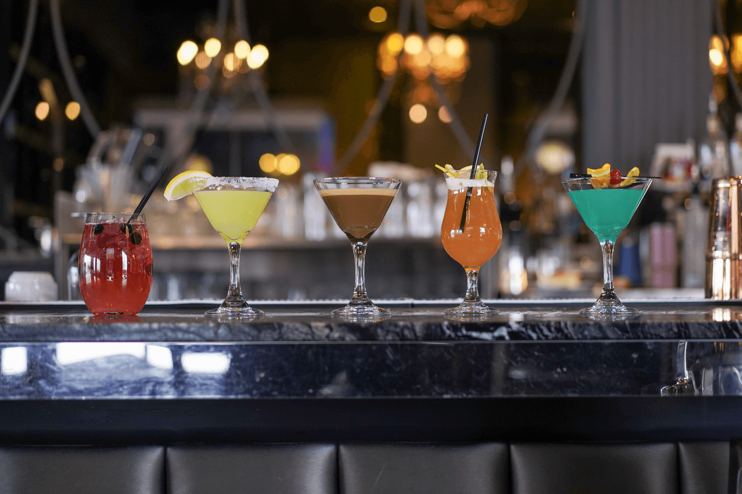 Lineup of colorful cocktails at the Sparkly bar