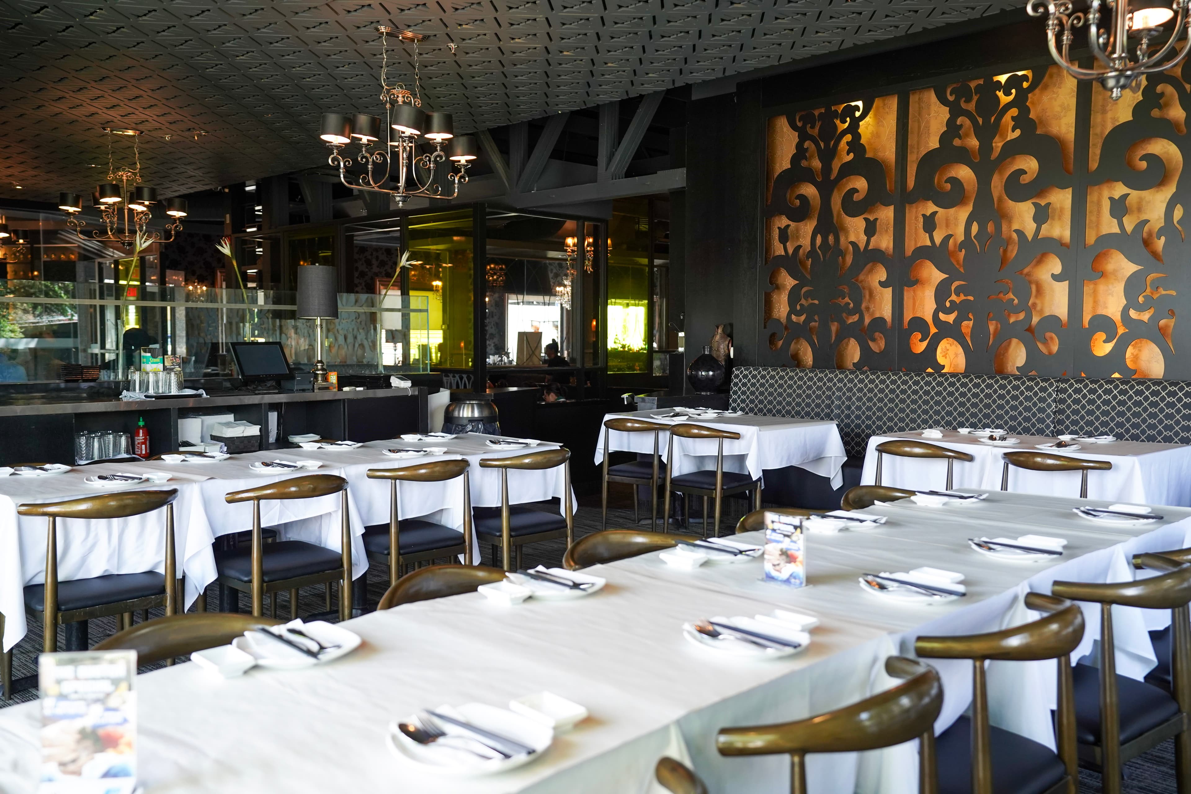 Sparkly Restaurant bar interior with chandeliers and warm lighting